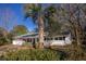 Charming single story home featuring a well-manicured lawn and a beautiful palm tree, providing a warm and inviting curb appeal at 412 Arlington Dr, Charleston, SC 29414