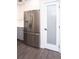 Close-up of the stainless steel refrigerator in a renovated kitchen with grey flooring at 412 Arlington Dr, Charleston, SC 29414