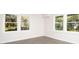 Sun-filled living room featuring large windows, hardwood floors, and white trim at 412 Arlington Dr, Charleston, SC 29414