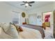 Bedroom with neutral tones, large window, double door closet, and a view into the living room at 429 Pender Woods Dr, Summerville, SC 29486