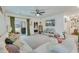 Bright living room featuring a plush sofa, a ceiling fan, and sliding glass doors to the backyard at 429 Pender Woods Dr, Summerville, SC 29486