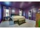 A purple-themed main bedroom with a large bed, stylish decor, and ample natural light from two windows at 429 Pender Woods Dr, Summerville, SC 29486