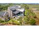 Breathtaking aerial view of a luxurious home with a private pool surrounded by lush greenery and marshland at 430 Fish Tale Rd, Charleston, SC 29492