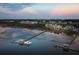 Scenic aerial view of waterfront homes and a private boat dock under a beautiful sky with a moon at 430 Fish Tale Rd, Charleston, SC 29492