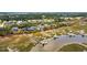 Expansive aerial view of waterfront homes with private docks and lush greenery at 430 Fish Tale Rd, Charleston, SC 29492