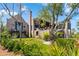 Expansive backyard featuring lush green grass, mature trees, and a charming brick home exterior with multiple balconies at 430 Fish Tale Rd, Charleston, SC 29492