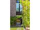 Secluded backyard with a wooden swing, lush greenery, and a brick-paved path, creating a tranquil outdoor space at 430 Fish Tale Rd, Charleston, SC 29492
