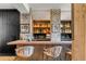 Stylish home bar with a wooden countertop, rustic brick accents, and well-stocked shelves for an elevated entertainment experience at 430 Fish Tale Rd, Charleston, SC 29492