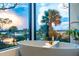 Luxurious bathroom with freestanding tub next to a large window featuring a sunset view at 430 Fish Tale Rd, Charleston, SC 29492
