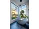 Tranquil bathroom featuring a standalone tub and expansive window with beautiful sunset view at 430 Fish Tale Rd, Charleston, SC 29492
