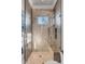 Beautifully tiled shower with glass enclosure, shower bench, and window at 430 Fish Tale Rd, Charleston, SC 29492
