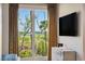 Bedroom with beautiful marsh views, dresser, and mounted tv at 430 Fish Tale Rd, Charleston, SC 29492