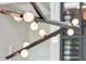 Modern dining room chandelier with a bronze mount and frosted glass globes at 430 Fish Tale Rd, Charleston, SC 29492