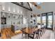 Open dining and kitchen area with wooden table, beams, and view through the windows at 430 Fish Tale Rd, Charleston, SC 29492
