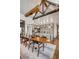 Open dining and kitchen area with wooden table, wine storage, and stone countertops at 430 Fish Tale Rd, Charleston, SC 29492