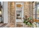 Brick entryway with view to kitchen with white cabinets and island at 430 Fish Tale Rd, Charleston, SC 29492