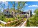 Stunning home exterior with a wooden bridge leading to a beautifully landscaped yard, showcasing architectural elegance at 430 Fish Tale Rd, Charleston, SC 29492
