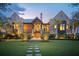 Picturesque home with lush lawn, illuminated pathway, and striking architectural details at 430 Fish Tale Rd, Charleston, SC 29492