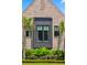 Close-up of a beautiful brick facade with windows and lush landscaping below at 430 Fish Tale Rd, Charleston, SC 29492