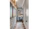 Hallway with exposed brick wall leading to a small office space with a desk and a view of the outdoors at 430 Fish Tale Rd, Charleston, SC 29492
