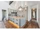 A spacious kitchen with a large center island, marble countertops, stainless appliances and hardwood floors at 430 Fish Tale Rd, Charleston, SC 29492