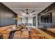 Cozy living room featuring a leather sectional, ceiling fan, and brick accents at 430 Fish Tale Rd, Charleston, SC 29492