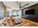 Open concept living room featuring a modern design with a large fan, brick accents, and a seamless connection to the dining area at 430 Fish Tale Rd, Charleston, SC 29492