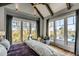 Bedroom featuring bright windows with marsh views, hardwood floors, and a cozy seating area, offering a serene escape at 430 Fish Tale Rd, Charleston, SC 29492