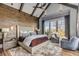Spacious main bedroom featuring wood accents, a large bed, and a seating area, creating a cozy and inviting retreat at 430 Fish Tale Rd, Charleston, SC 29492