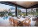 Stylish outdoor patio with dining and lounge areas overlooking a pool and waterfront at 430 Fish Tale Rd, Charleston, SC 29492