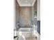 Modern shower featuring glass door, pebble tile floor, and built in shelving at 430 Fish Tale Rd, Charleston, SC 29492