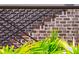 Detailed close-up featuring the stylish exterior stairs with intricate iron railing against a brick backdrop at 430 Fish Tale Rd, Charleston, SC 29492