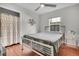 Bright bedroom features stylish decor, a comfortable bed, hardwood floors, and a window providing natural light at 4445 Old Park Rd, North Charleston, SC 29405
