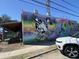 Colorful, modern mural on the side of a building features the logo for Tattooed Moose at 4445 Old Park Rd, North Charleston, SC 29405