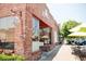 Charming brick facade with window and outdoor seating to encourage customers to enjoy food and atmosphere at 4445 Old Park Rd, North Charleston, SC 29405