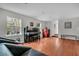 Bright living room featuring hardwood floors, a piano, a decorative rug, and large windows at 4445 Old Park Rd, North Charleston, SC 29405