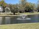 Scenic view of the community pond featuring a decorative fountain enhancing waterfront homes at 4445 Old Park Rd, North Charleston, SC 29405