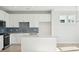 Modern kitchen with white cabinets, stylish backsplash, and stainless steel appliances, designed for culinary enthusiasts at 482 Queenview Ln, Charleston, SC 29414