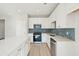 Bright kitchen features white cabinets, stainless appliances, tile backsplash, and spacious island at 482 Queenview Ln, Charleston, SC 29414