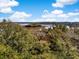 A stunning aerial view showcasing the home surrounded by lush greenery and waterfront scenery at 5010 Timber Race Crse, Hollywood, SC 29449