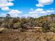 Scenic aerial view of wooded landscape with marsh and waterfront views under a partly cloudy sky at 5010 Timber Race Crse, Hollywood, SC 29449
