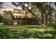 Expansive backyard view showcasing a spacious deck and large windows offering ample natural light at 5010 Timber Race Crse, Hollywood, SC 29449