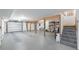 Spacious unfinished basement with garage door, support beams, and painted floor at 5010 Timber Race Crse, Hollywood, SC 29449