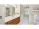 Bright bathroom with a large mirror, modern vanity, and tiled floors create a serene atmosphere at 5010 Timber Race Crse, Hollywood, SC 29449