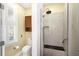 Bathroom featuring a tiled shower with a built-in seat and a toilet in an adjacent room at 5010 Timber Race Crse, Hollywood, SC 29449