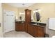 Bathroom featuring separate dark granite vanities, sconce lighting, and a tiled floor at 5010 Timber Race Crse, Hollywood, SC 29449