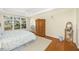 Bright bedroom with a large window, wood floors, and an armoire at 5010 Timber Race Crse, Hollywood, SC 29449