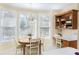 Breakfast nook with a table, chairs, and a built-in desk area near a bright window at 5010 Timber Race Crse, Hollywood, SC 29449