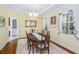 Bright dining room featuring hardwood floors, stylish window treatments, and adjacent access to laundry at 5010 Timber Race Crse, Hollywood, SC 29449