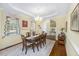 Traditional dining room with elegant chandelier, large window, and staircase access at 5010 Timber Race Crse, Hollywood, SC 29449